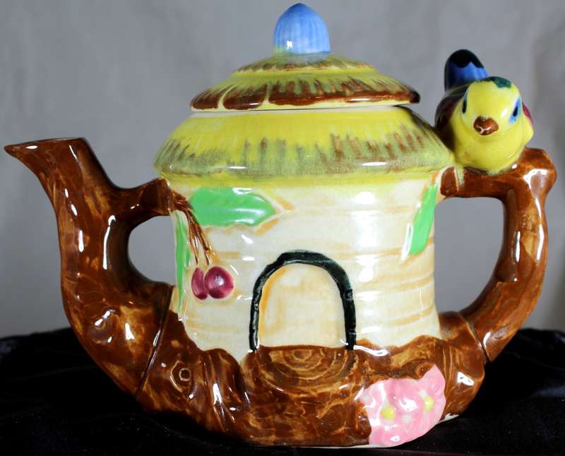 Small character teapot with bird and bungalow