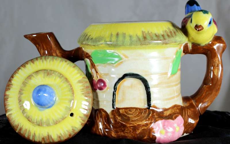 Small character teapot with bird and bungalow