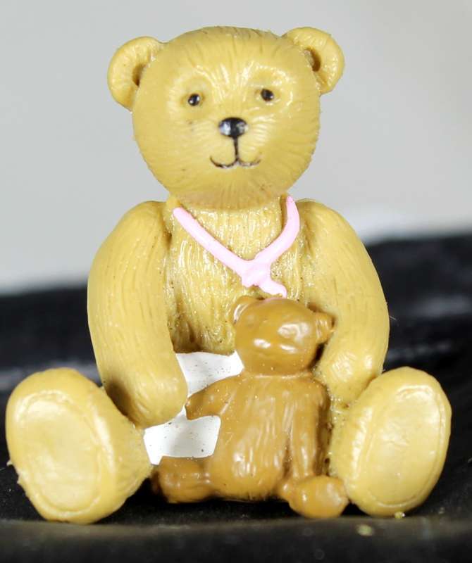 Miniature bear with toy