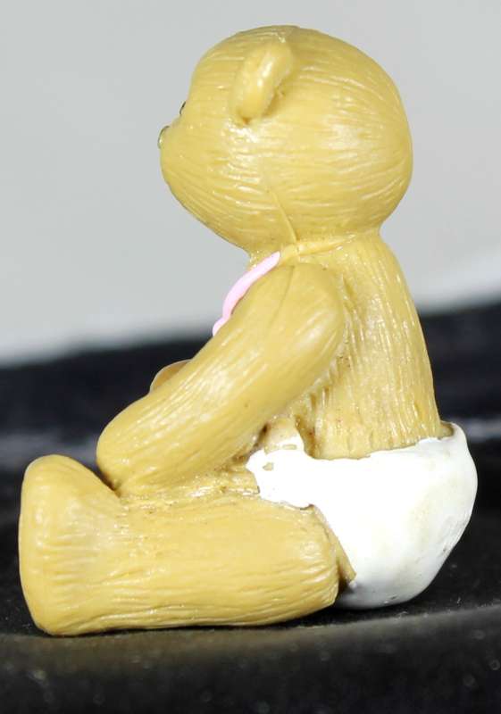 Miniature bear with toy