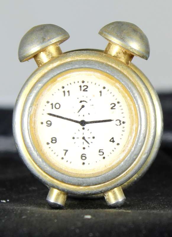 Miniature brass alarm clock