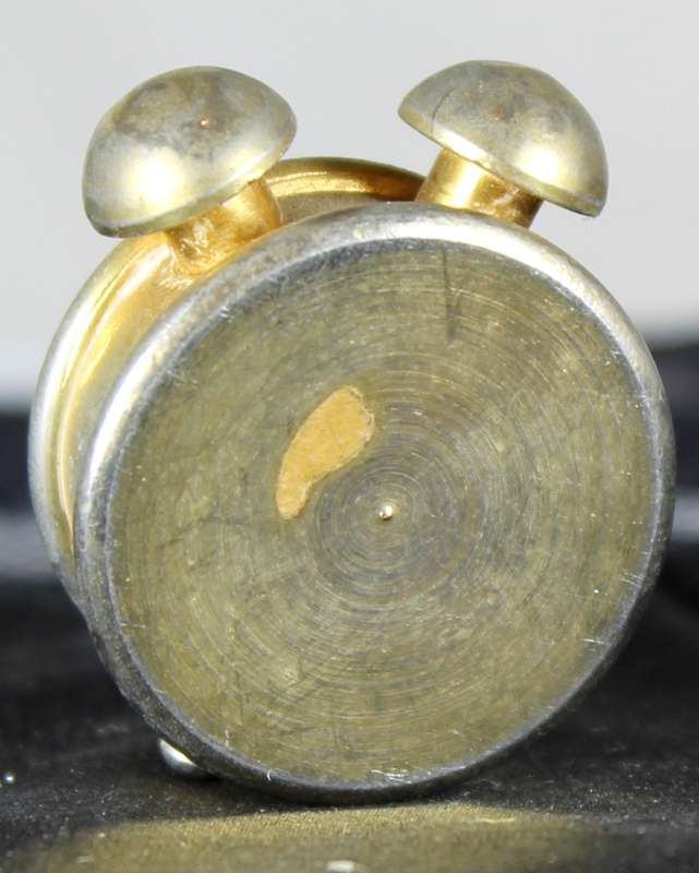 Miniature brass alarm clock