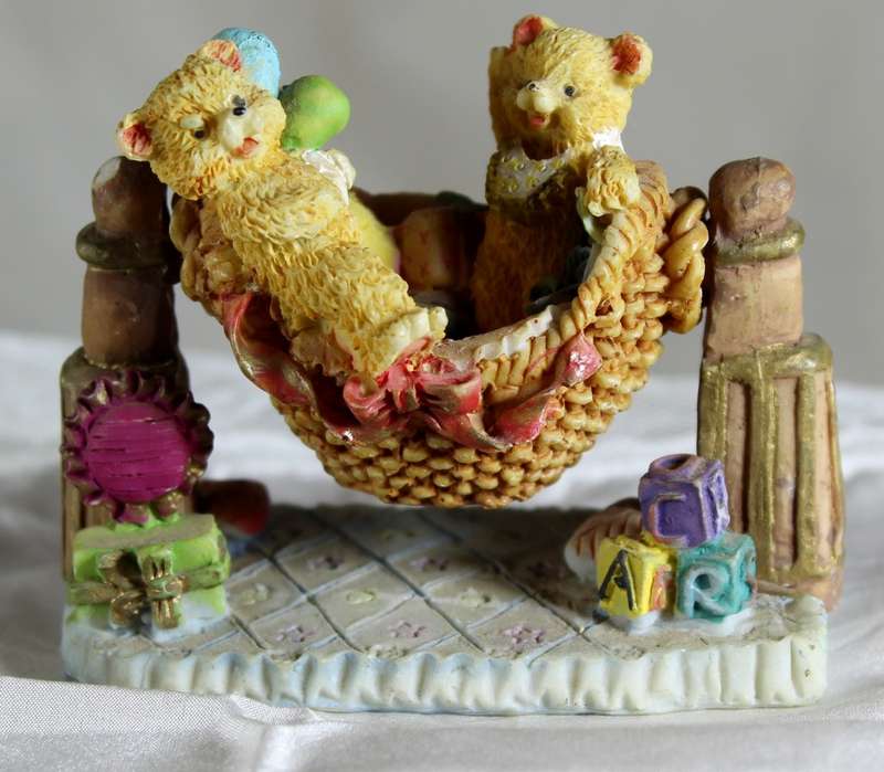 Two Bears Standing on a Swing