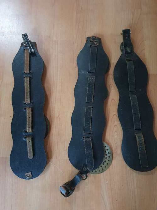 3 vintage horse brasses on black leather straps.