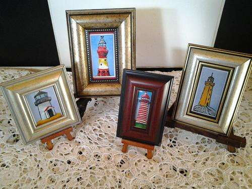 A Stunning set of 4x Lighthouse paintings in extra ornate frames..... Great buy.