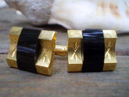 Beautiful vintage cufflinks with an onyx stone in a golden wavy metal frame, cool design