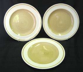Three Susie Cooper side plates -- Spirals (Old Gold) pattern