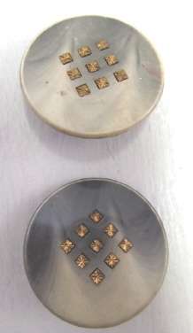 Pair of large vintage plastic and metal buttons