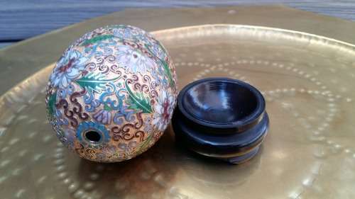 Beautiful brass enameled ornate oriental Cloisonne Egg on carved wooden stand. 14cm