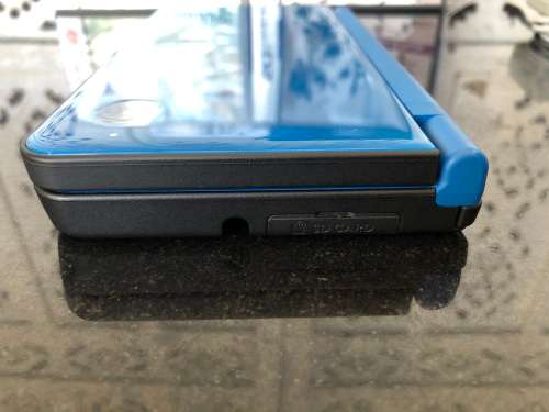 NINTENDO DSi XL GAME CONSOLE IN ORIGINAL BOX WITH CHARGER AND MANUAL FULL WORKING ORDER WITH 2 GAMES