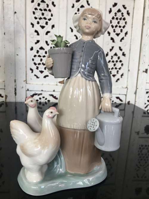 A LLADRO Porcelain Figurine, Country Girl with Plant & Water Can in Hands Ducks at feet.