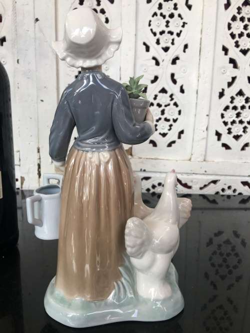 A LLADRO Porcelain Figurine, Country Girl with Plant & Water Can in Hands Ducks at feet.