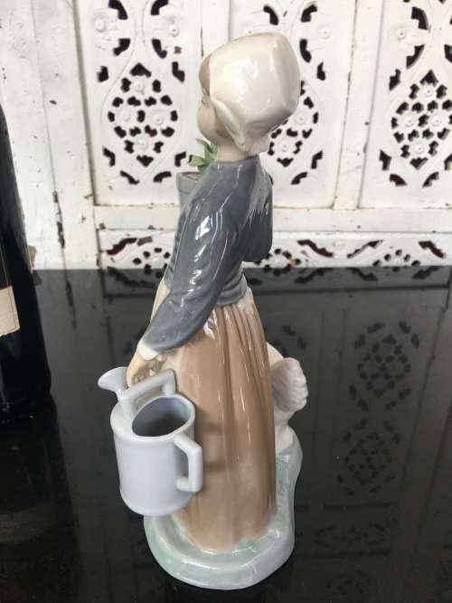 A LLADRO Porcelain Figurine, Country Girl with Plant & Water Can in Hands Ducks at feet.