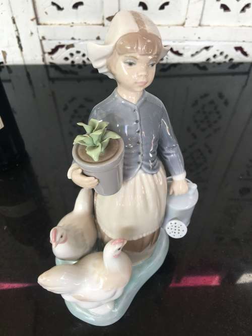 A LLADRO Porcelain Figurine, Country Girl with Plant & Water Can in Hands Ducks at feet.