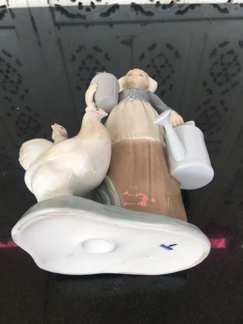 A LLADRO Porcelain Figurine, Country Girl with Plant & Water Can in Hands Ducks at feet.