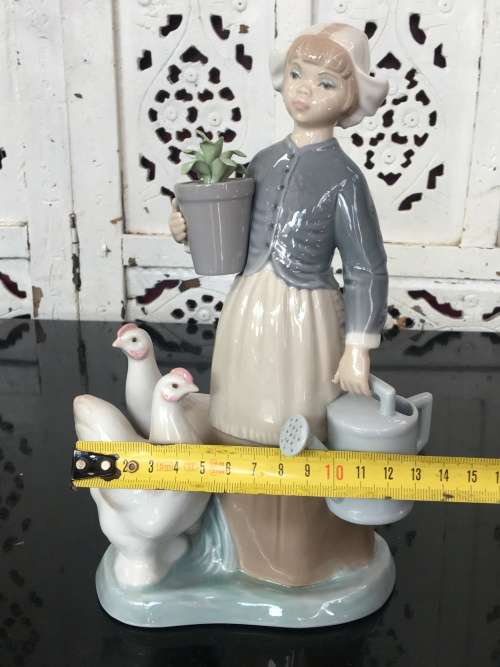 A LLADRO Porcelain Figurine, Country Girl with Plant & Water Can in Hands Ducks at feet.