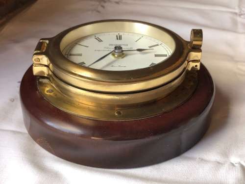 STUNNING GERMAN BRASS PORTHOLE SHIPS CLOCK ON A MAHOGANY BASE - QUARTZ MOVEMENT - WORKING