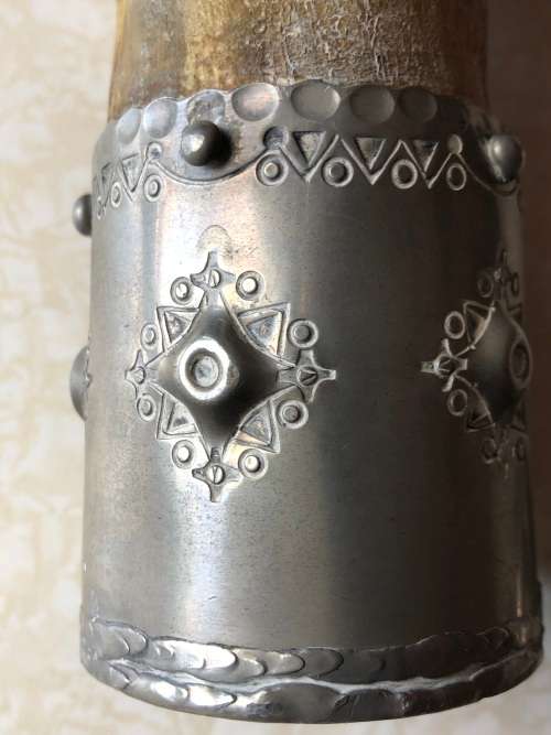 A pewter mounted powder horn with removable top, with engravings and embossed decoration