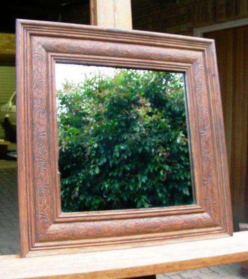 Vintage wooden mirror with broad carved border