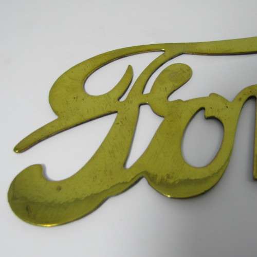Antique brass Ford Model T radiator grille badge