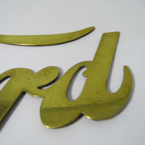 Antique brass Ford Model T radiator grille badge