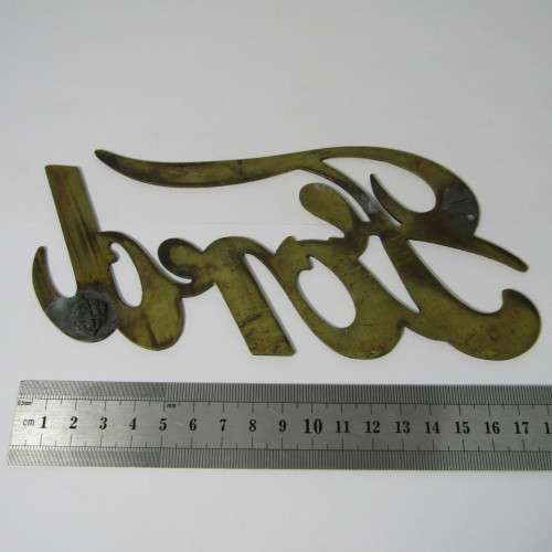Antique brass Ford Model T radiator grille badge