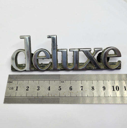 Vintage Mazda deluxe car badge