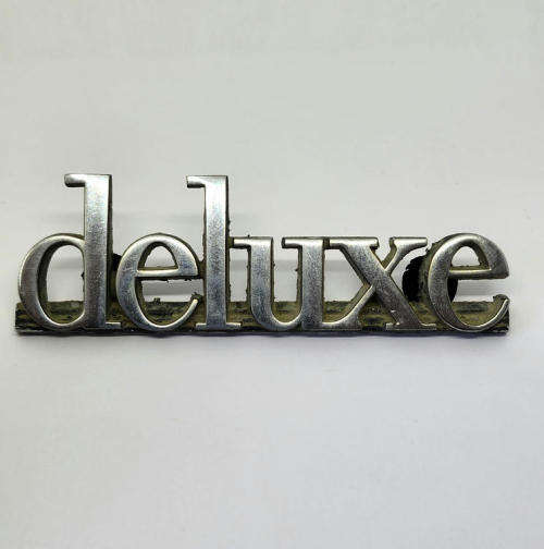 Vintage Mazda deluxe car badge