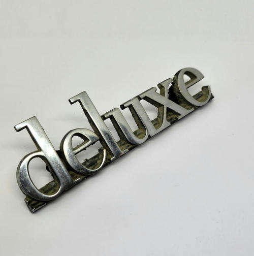 Vintage Mazda deluxe car badge