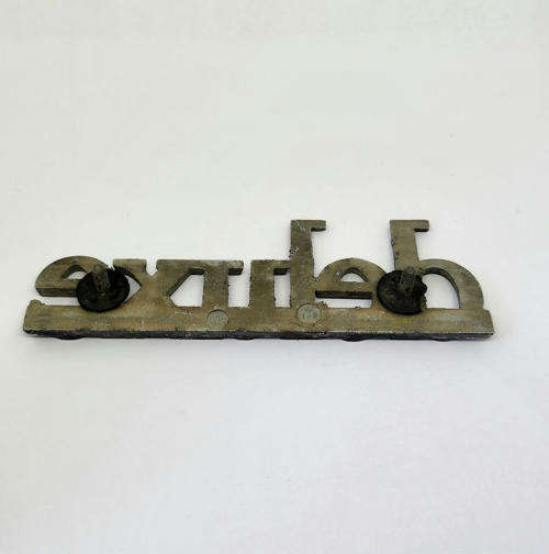 Vintage Mazda deluxe car badge