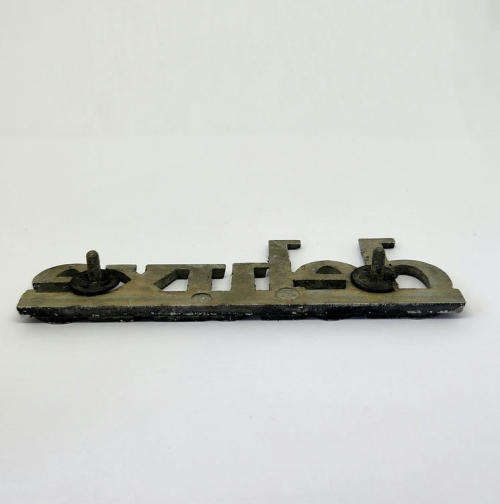 Vintage Mazda deluxe car badge