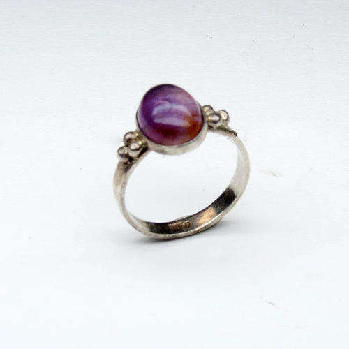 Silver ring with purple stone in