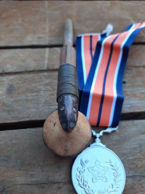 vintage war smoking pipe and medal