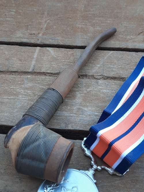vintage war smoking pipe and medal