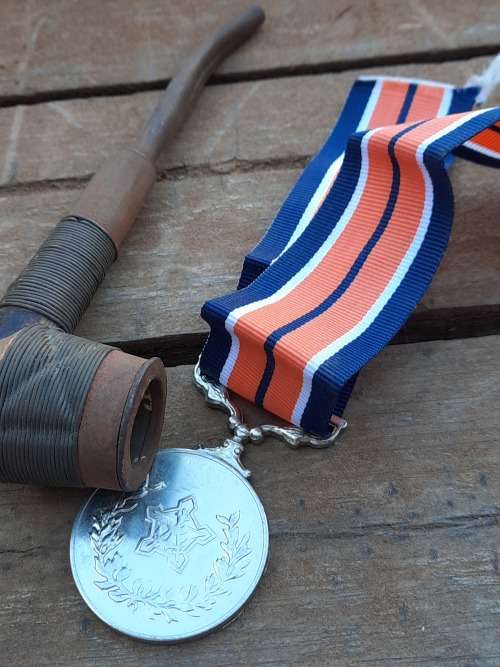 vintage war smoking pipe and medal