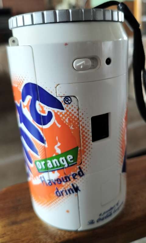 Vintage plastic camera in shape of Fanta Orange can