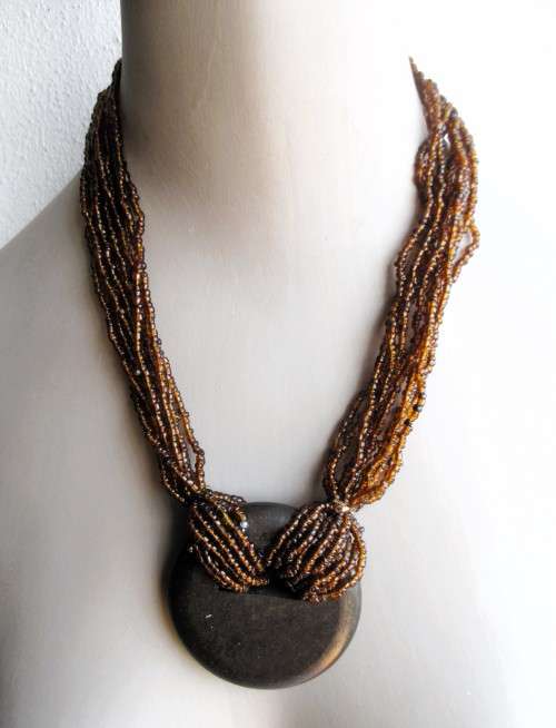 Vintage 11 strand glass bead African Necklace with dalk wood pendant. 50mm long.