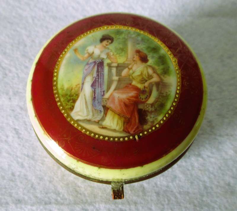 German Porcelain Round Trinket Box with hand painted gilt, brass hinge and rim. Pastoral Scene.