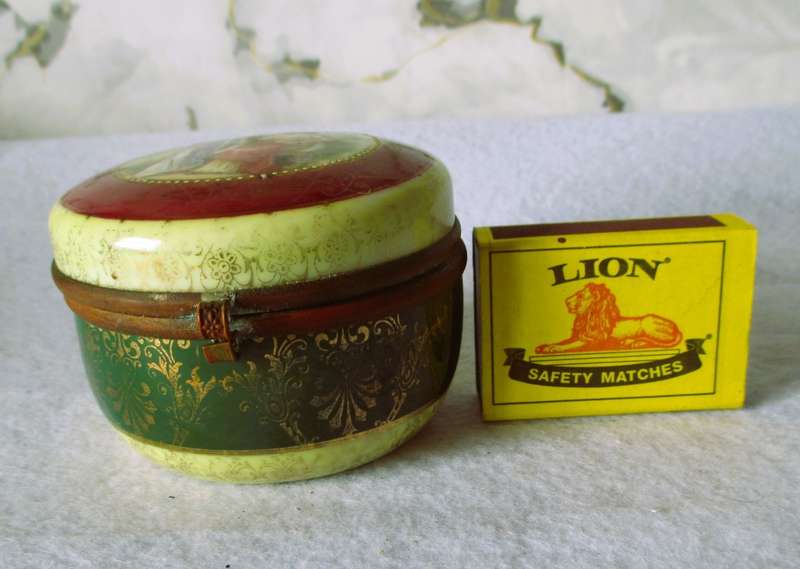 German Porcelain Round Trinket Box with hand painted gilt, brass hinge and rim. Pastoral Scene.