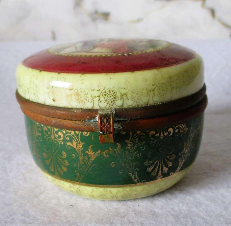 German Porcelain Round Trinket Box with hand painted gilt, brass hinge and rim. Pastoral Scene.