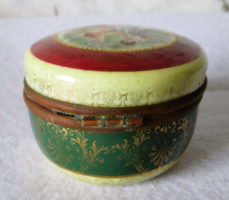 German Porcelain Round Trinket Box with hand painted gilt, brass hinge and rim. Pastoral Scene.