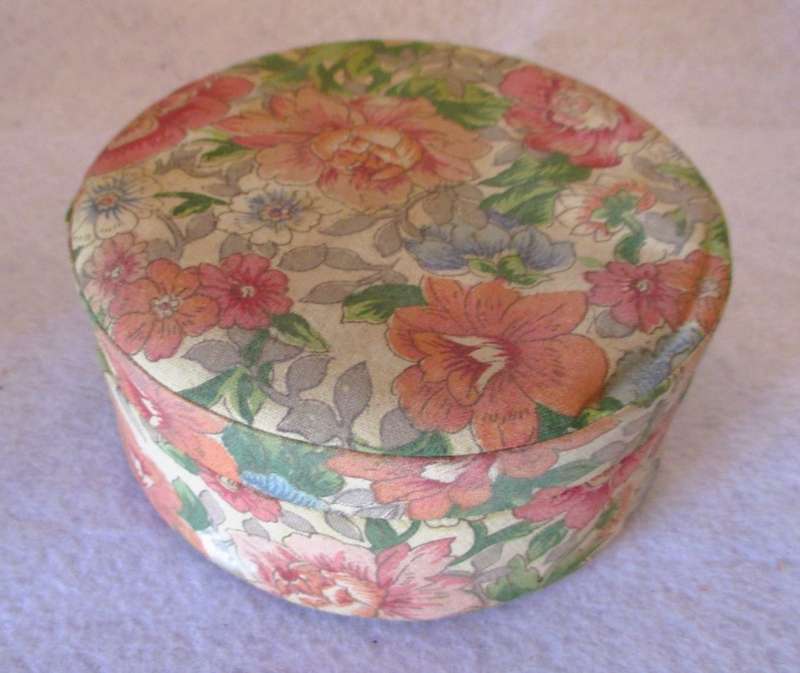 Vintage Valeur round Powder container, covered with material, contains some vintage jewelry.