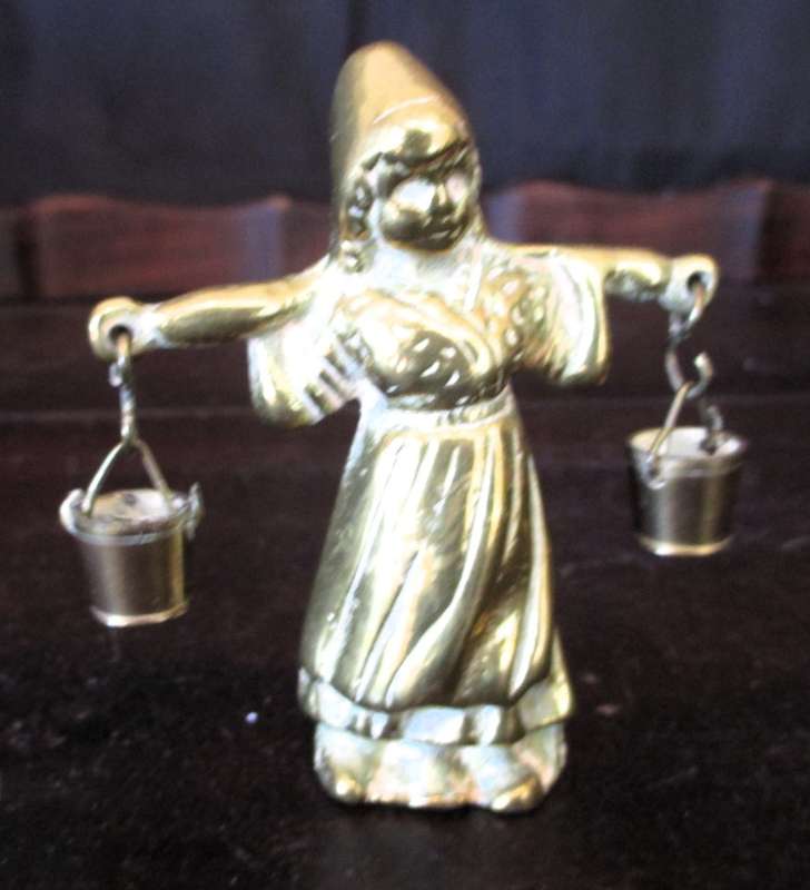 Antique brass figurine girl carrying two milk baskets. Marked.