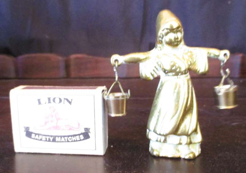 Antique brass figurine girl carrying two milk baskets. Marked.