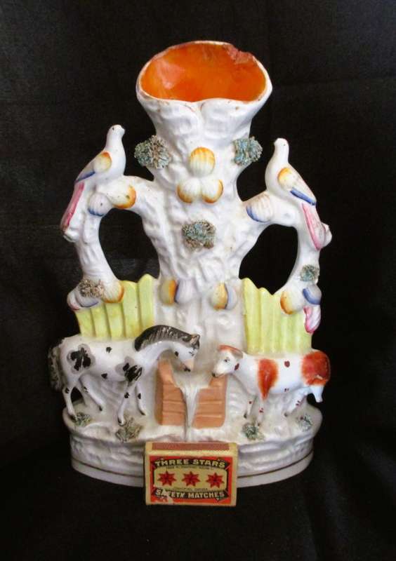 A Victorian Staffordshire spill, a cow and horse drinking from a trough beneath birds. Chip. 25x16cm