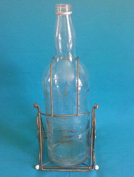 LARGE BELL'S SCOTCH WHISKY BOTTLE ON STAND