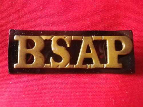 RHODESIA BSAP - SUPPORT UNIT BRASS SHOULDER TITLE ON BLACK PLASTIC  (7678)