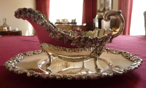 Dramatic silver plated sauce boat on stand