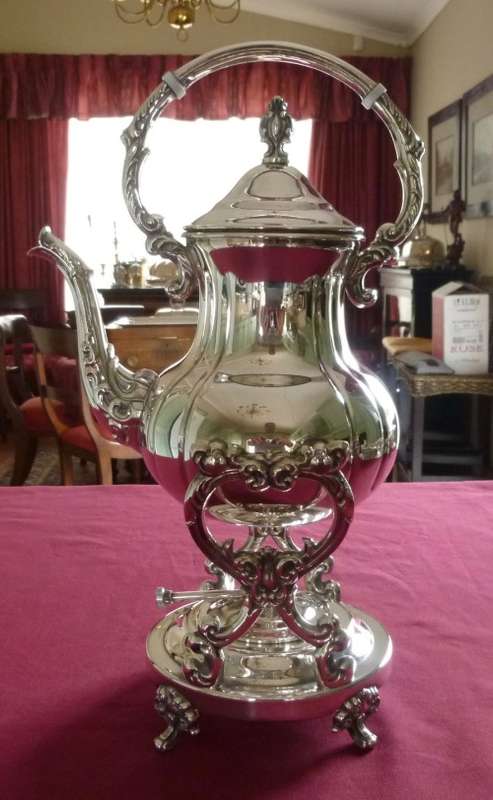 Silver plated tea kettle on stand