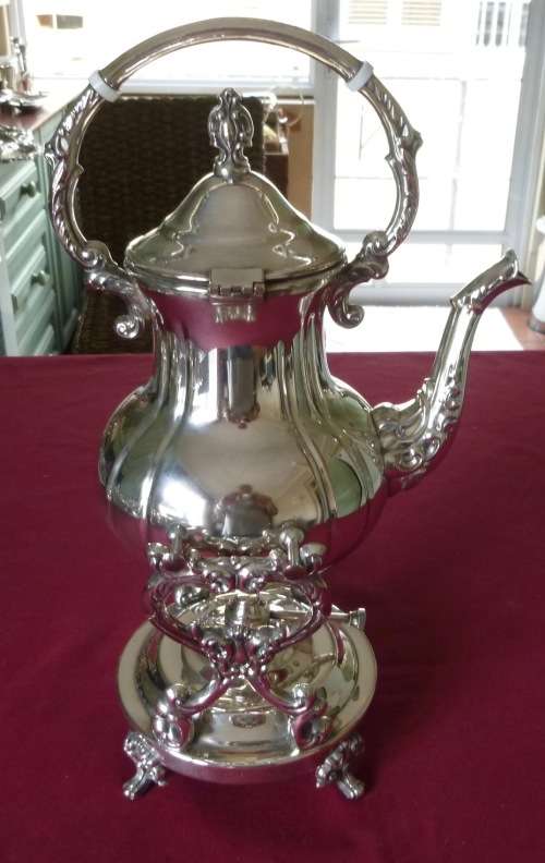 Silver plated tea kettle on stand